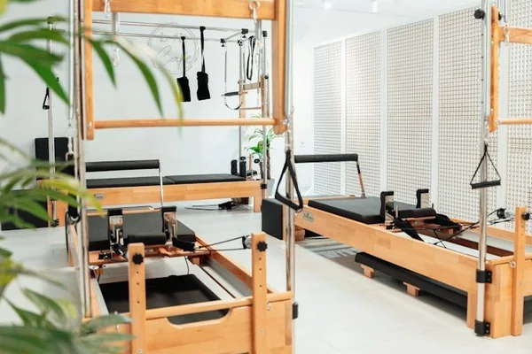 Bright pilates studio with wooden reformers